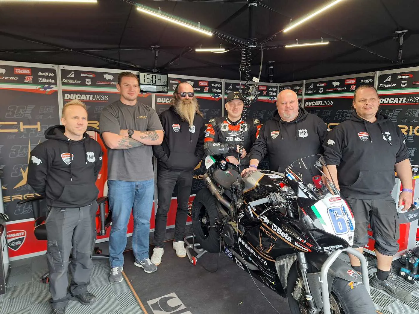 Juho Kantola and the Ducati JK36 team in the paddock with the race bike